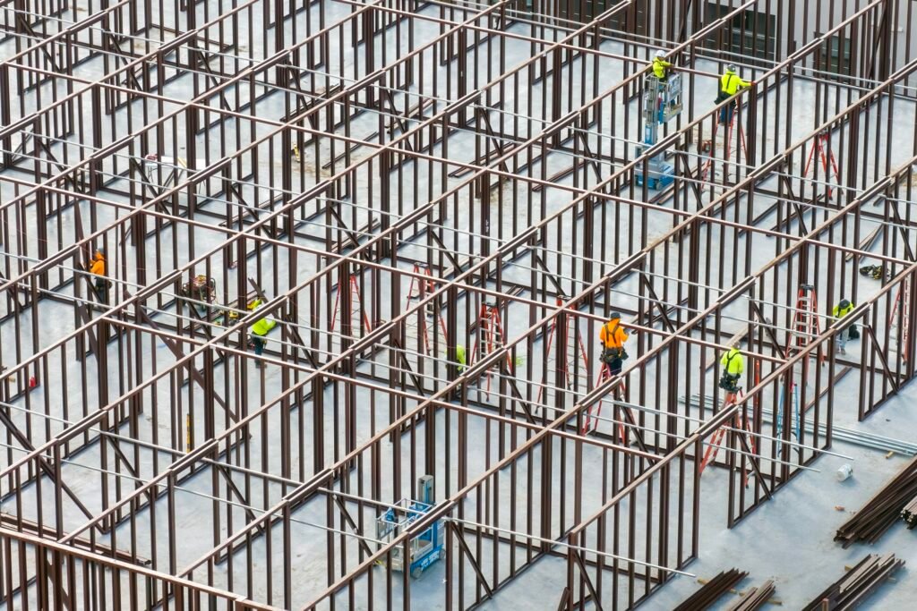 Construction works on metal walls of commercial building.